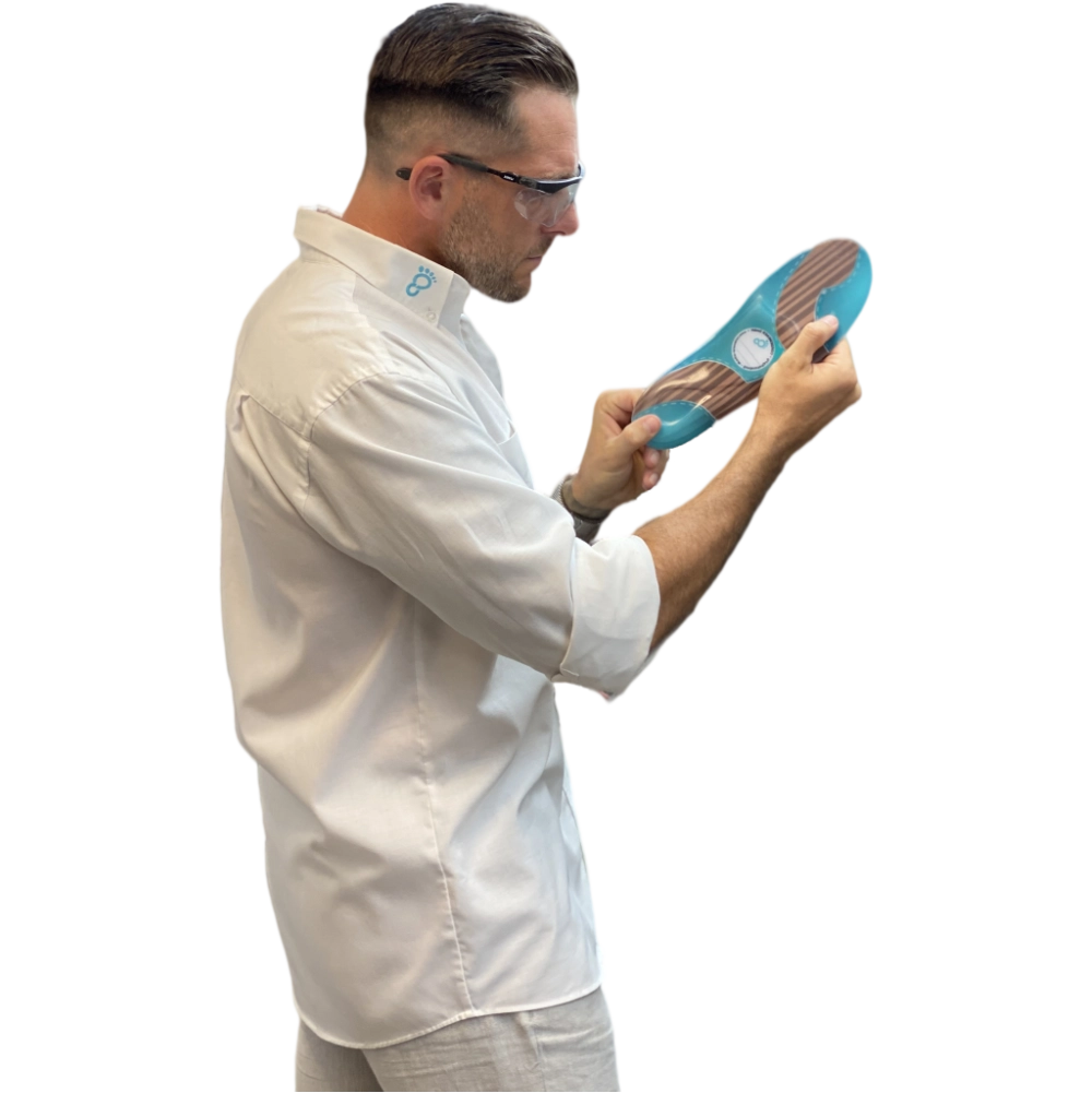 Man in white shirt holding insole