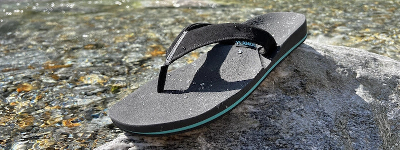 Ylamog on stone with water in background