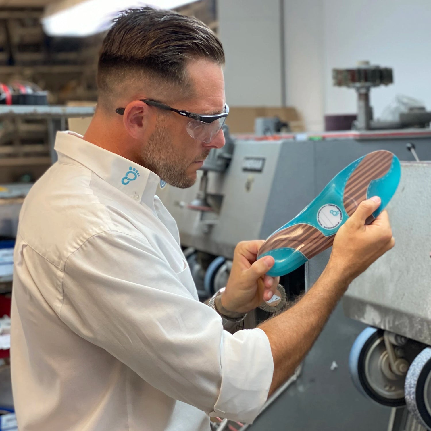 Dave Cordewener standing in front of machines looking at an insole